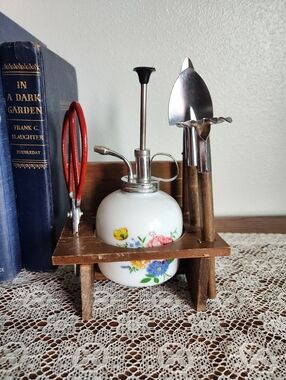 Floral Plant Mister and Mini Garden Tool Set On Wooden Bench